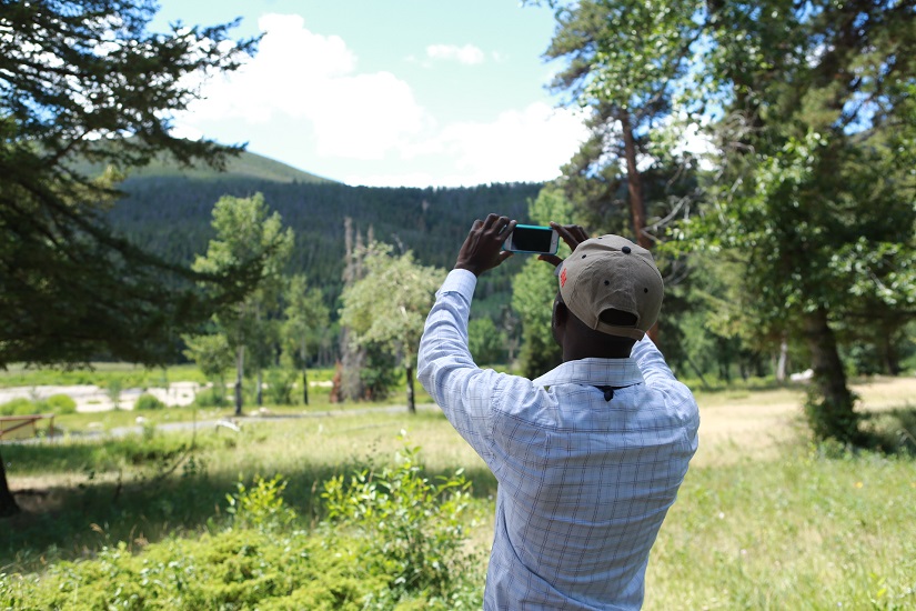 Citizen scientist taking pictures of the sky out doors.