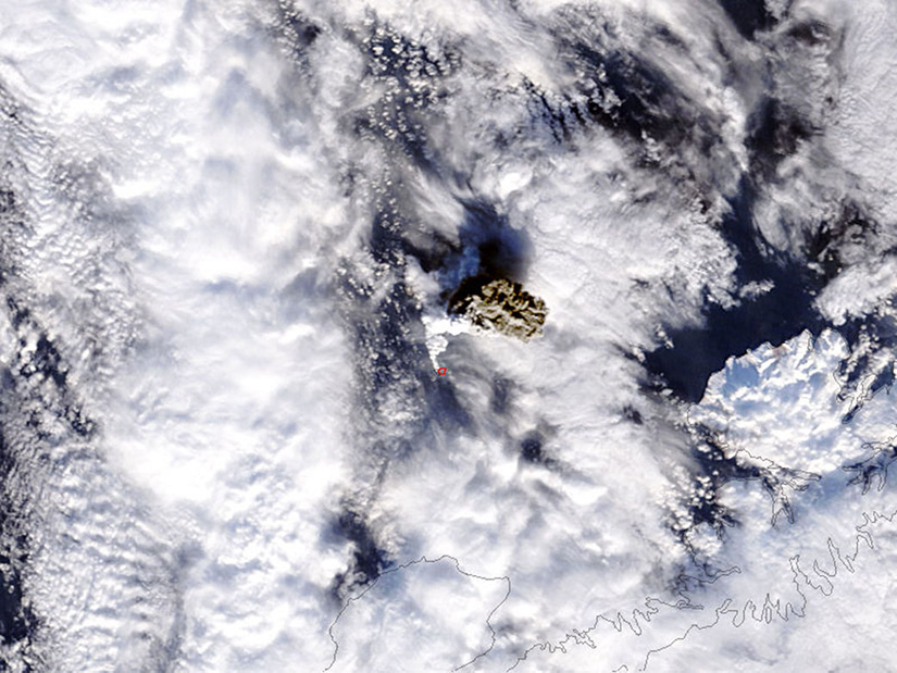 A satellite view of clouds around a volcanoe.
