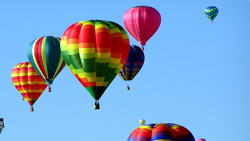 A sky filled with hot air balloons.