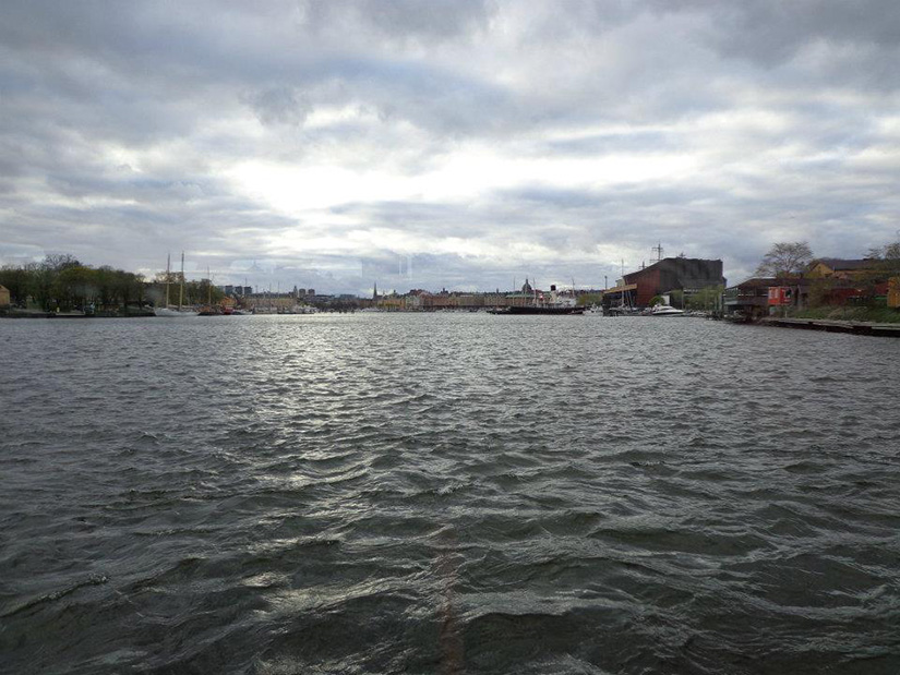 A view of water with city scapes on both sides.