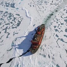 A boat on a frozen body of water.