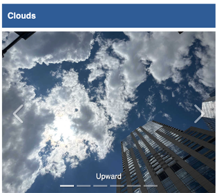 Upward photo of clouds and a building.