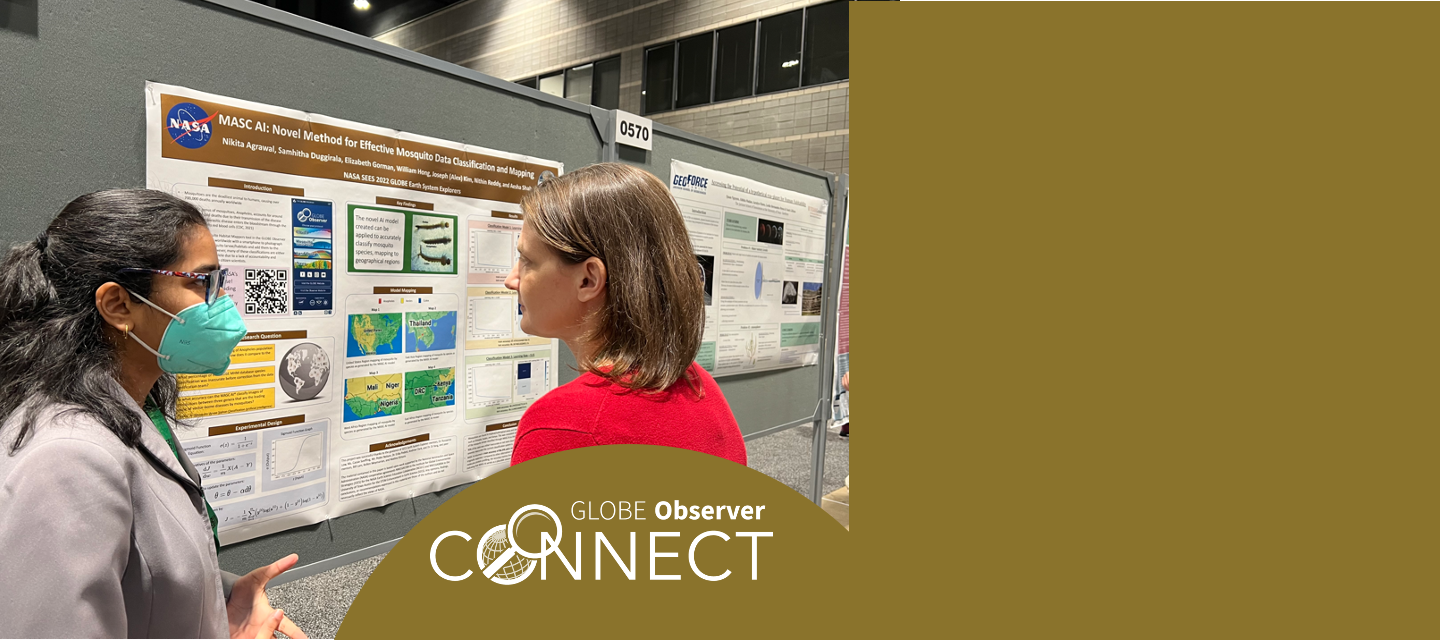 A student stands presenting about her poster to a professional scientist.