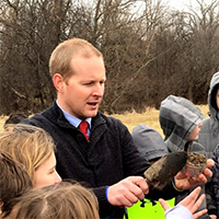 Jeff holding soil with his students