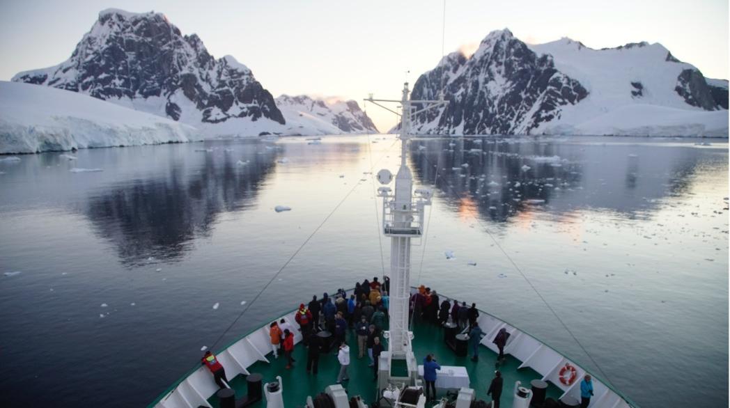 A photo of people gathered on the bow of a tour expedition ship in Antarctica. Courtesy Allison Cusick.