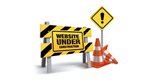 Caution yellow sign with a orange construction cone saying: Website Under Construction